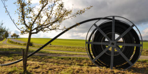 Image of a spool of cable in a field.