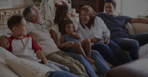 Image of a family laughing and watching tv